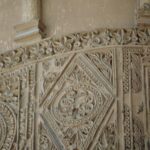 Carved stucco panel from one of the towers flanking the entrance portal2