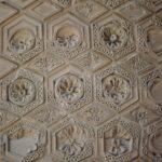 Detail of a carved stucco panel from one of the towers flanking the entrance portal